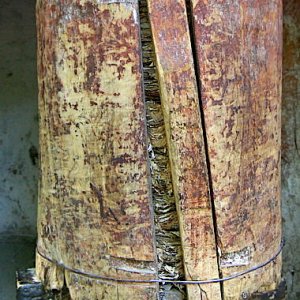 Old prayer wheel with the tightly wrapped rolls of mantras inside.