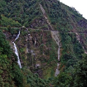 Many roadsd in Bhutan are cut out of ledges along the sides of steep valleys