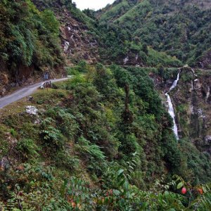 The road is cut out along a ledge on the cliff face of Narling Dra, Bhutan