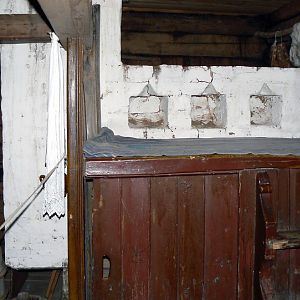 Kostroma, Museum of Wooden Architecture, home of a poor peasant - stove with sleeping area above and cupboard for sickly calves