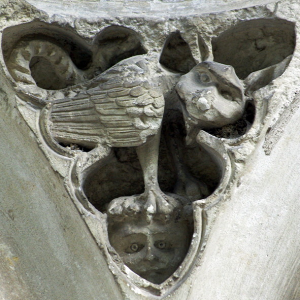 Cormery, basilisk overpowering a monk on the wall of the chapter house.png
