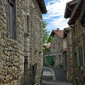 Roche-en-Régnier - curved street with houses on right built into town wall