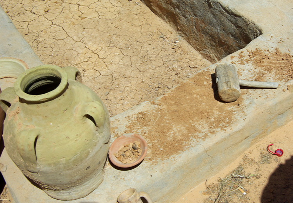 Guellala pottery - breaking up the clay to mix with fresh water (red pots) or sea water (white pots)