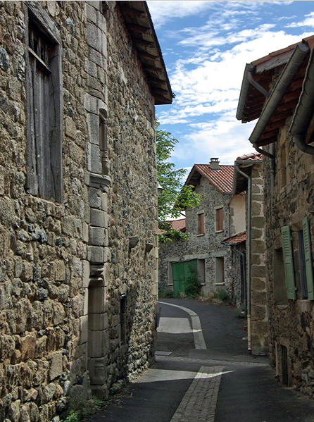 Roche-en-Régnier - curved street with houses on right built into town wall