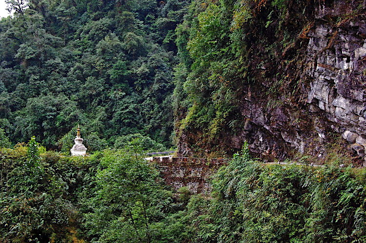 The road is cut out along a ledge on the cliff face of Narling Dra, Bhutan
